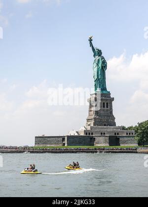 A vertical shot of the Statue of Liberty in New York City, in the ...
