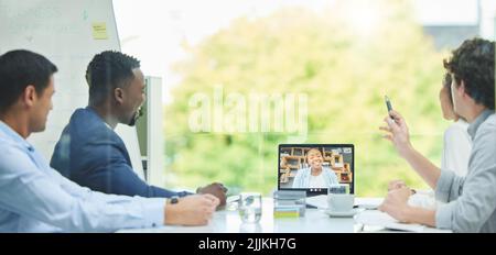 We wanted to run something by you. a team of staff having a virtual meeting using a laptop. Stock Photo