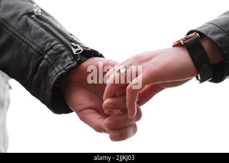 The closeup shot of a couple  hands together on white background Stock Photo