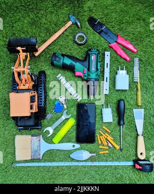 A top view of different tools on the green grass Stock Photo
