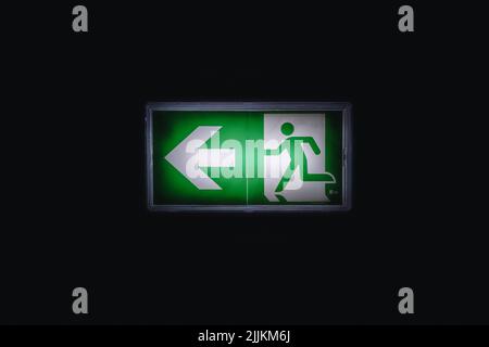 Emergency sign with light in a dark corridor Stock Photo