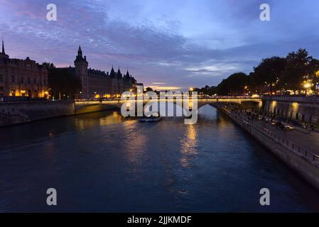 A beautiful view of the Bridge Pont au Change in the evening in Paris, France Stock Photo