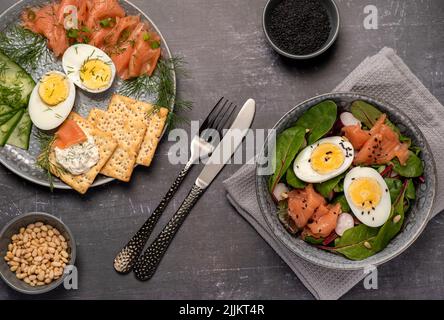 Food photography of salad, boiled eggs, salmon, crackers Stock Photo