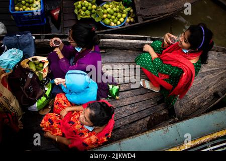 A seller arriving at Bhimruli Floating Market with Guavas on the boats for selling in wholesale market Stock Photo