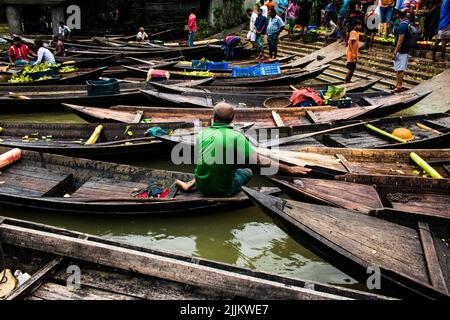 A seller arriving at Bhimruli Floating Market with Guavas on the boats for selling in wholesale market Stock Photo