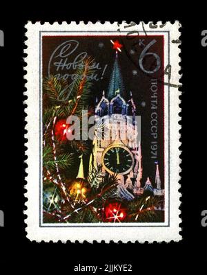 Kremlin tower with red star, decorated fir-tree for New Year, circa 1970. Happy New Year 1971 as text. canceled stamp printed in the USSR Stock Photo