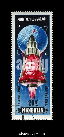 Yury Gagarin (1934-1968), first russian, soviet astronaut in the space, space-vehicle shuttle, circa 1961. vintage post stamp isolated on black Stock Photo