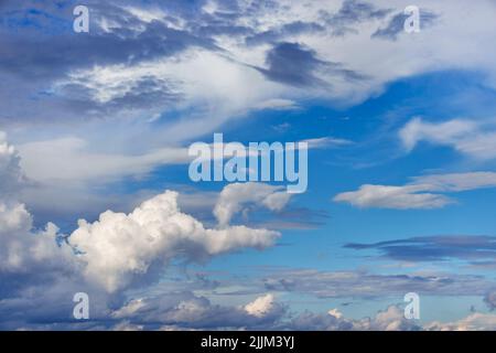 Beautiful curly white clouds on a blue sky. Stock Photo