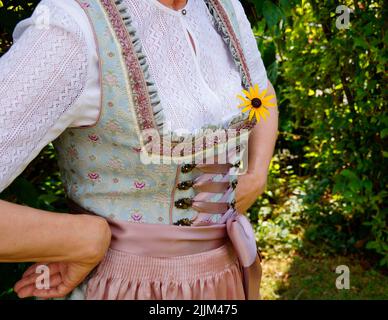 a woman in a beautiful traditional Bavarian dirndl dress at the Bavarian October fest (Oktoberfest) (Munich, Bavaria, Germany) Stock Photo