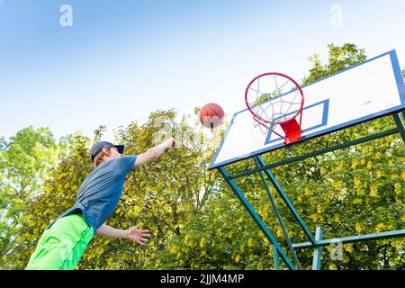 boy playing basketball outdoor Stock Photo