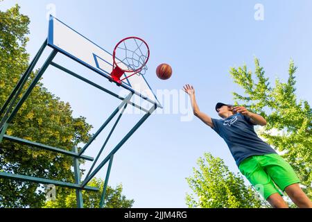 boy playing basketball outdoor Stock Photo