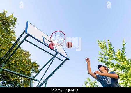 boy playing basketball outdoor Stock Photo