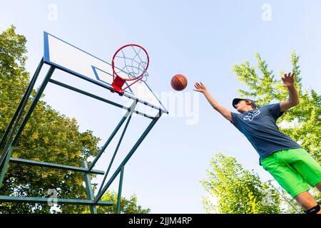 boy playing basketball outdoor Stock Photo