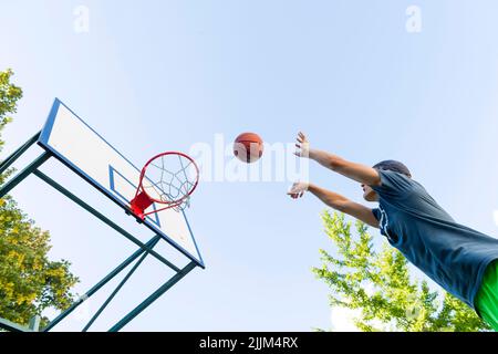 boy playing basketball outdoor Stock Photo