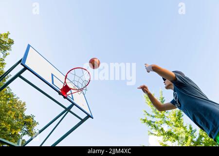 boy playing basketball outdoor Stock Photo