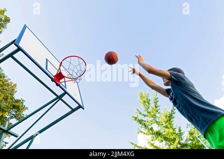 boy playing basketball outdoor Stock Photo