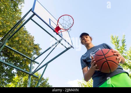 boy playing basketball outdoor Stock Photo