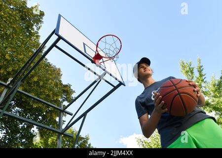 boy playing basketball outdoor Stock Photo