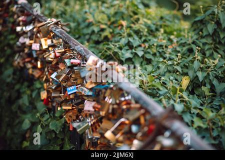 A closeup shot of love locks on a metal pole in the center of Zagreb, Croatia Stock Photo