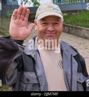 grandfather smiling happy waving hand greeting Happy old man senior thumbs up Stock Photo
