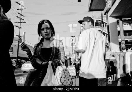 The streets of downtown Los Angeles with random people and shops in grayscale Stock Photo