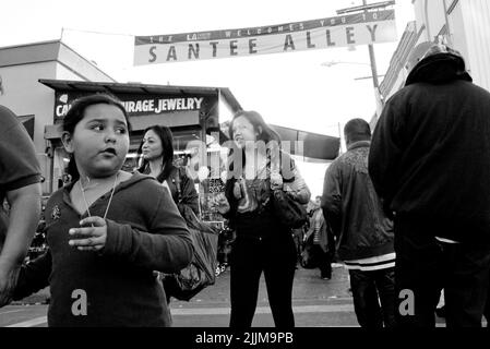 A shallow focus of random people shopping along Santee Alley in downtown Los Angeles in grayscale Stock Photo