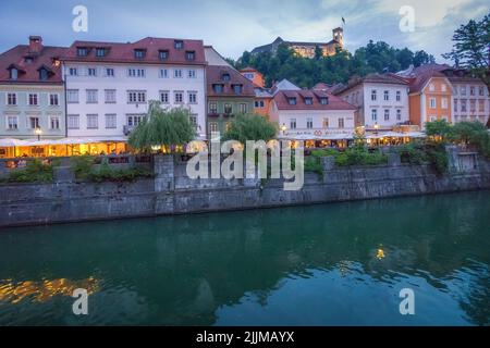 A beautiful shot of a river in the background of buildings in Ljubljana. Stock Photo