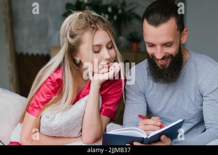 newlyweds honeymoon plan couple make notes Stock Photo