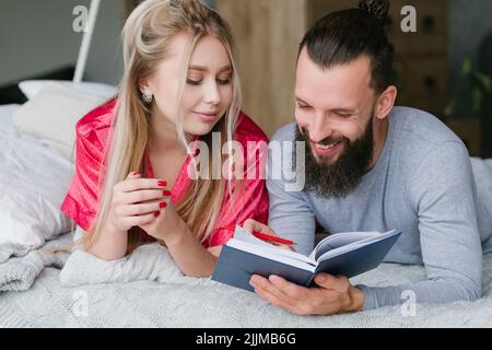 family morning vacation planning man woman notes Stock Photo