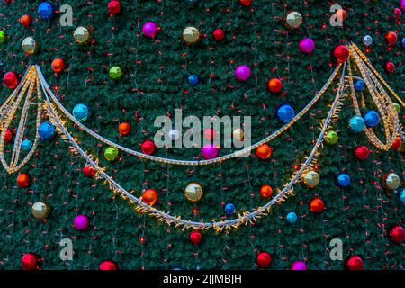 The decorative ornaments and decorations with lights on the Christmas tree Stock Photo