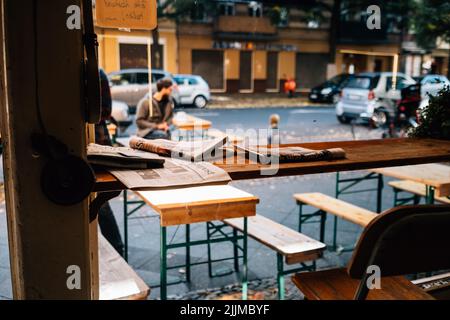 A closeup shot of some newspapers on a wooden table Stock Photo