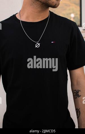 A vertical shot of a stylish young Caucasian male with tattoos Stock Photo
