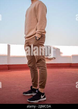A vertical shot of a stylish young Caucasian male Stock Photo