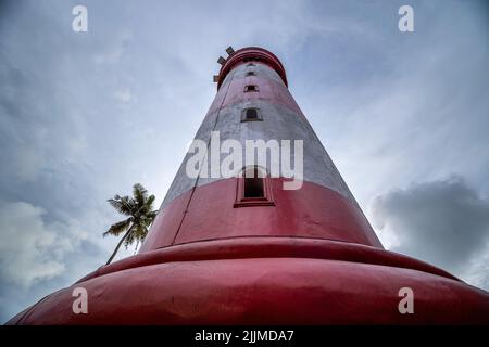 A low angle of an old lighthouse under a gloomy sky Stock Photo