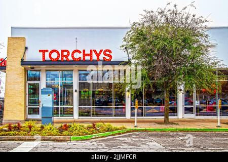 2019 02 06 Tulsa, USA - Torchys Taco Resturant with Retro Neon sign and bright colors showing through glass windows on overast day Stock Photo