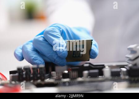 Computer engineers hand is holding cpu processor Stock Photo