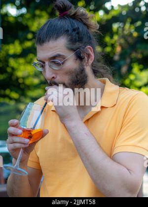 Young man finishing a cocktail Stock Photo
