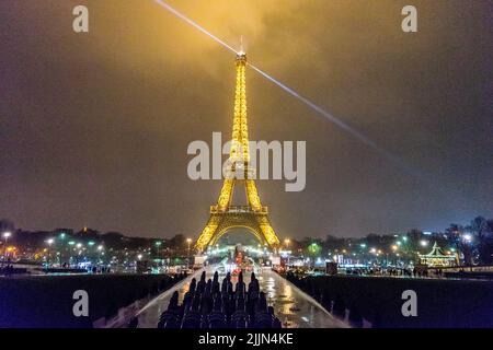 A vertical night view of the enchanting Eiffel Tower along with the Paris city skyline in France. Stock Photo