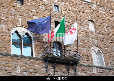 The flags of the European Union, Italy, and Florence are on the balcony. Stock Photo