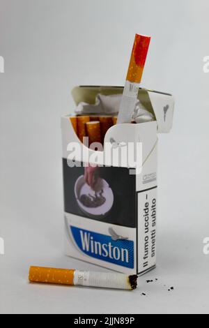 A closeup of a pack of Winston cigarettes with a red lipstick stain against the white background Stock Photo