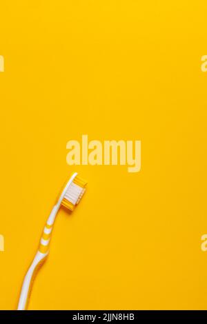 Pink toothbrush on yellow background for oral hygiene to clean teeth ...
