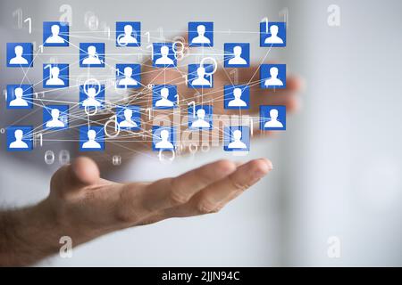 The 3d rendered profile icons hovering over a man's hand Stock Photo