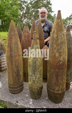 Mellenthin, Germany. 27th July, 2022. Robert Mollitor, head of the Ammunition Salvage Service in Mecklenburg-Western Pomerania, shows shells rendered harmless using various methods at the site of the Ammunition Salvage Service on the island of Usedom.The Ammunition Salvage Service is reportedly responsible for the disposal of all ordnance or explosive weapons of war. Credit: Stefan Sauer/dpa/Alamy Live News Stock Photo