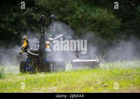 Mellenthin, Germany. 27th July, 2022. A remote-controlled manipulator drives toward an ammunition box for training purposes on the premises of the Ammunition Salvage Service on the island of Usedom. The special vehicle is intended for defusing so-called unconventional explosive and incendiary devices as well as suitcase bombs or letter bombs. The Ammunition Salvage Service is reportedly responsible for the disposal of all ordnance or explosive weapons of war. Credit: Stefan Sauer/dpa/Alamy Live News Stock Photo