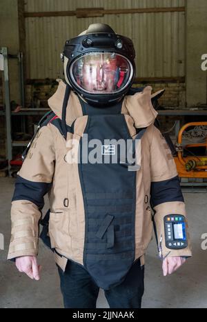 Mellenthin, Germany. 27th July, 2022. Christian Pegel (SPD), Minister of the Interior of Mecklenburg-Western Pomerania, wears a protective suit for defusing agents at the site of the Munitions Salvage Service on the island of Usedom. The Munitions Salvage Service is reportedly responsible for the disposal of all explosive ordnance or explosive weapons of war. Credit: Stefan Sauer/dpa/Alamy Live News Stock Photo