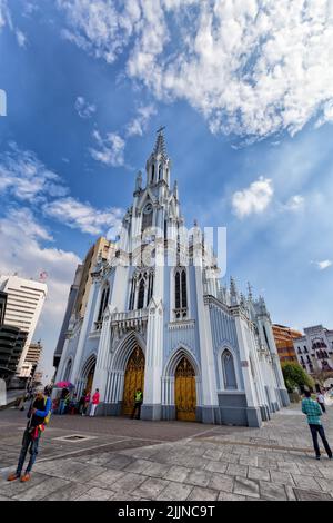 The Portrait view of people walking past the gothic La Ermita Church in Cali, Colombia Stock Photo