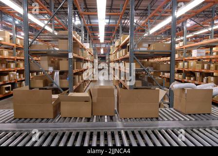 The Packages on a conveyor belt in a large warehouse ready for shipping in Saint Louis, Missouri USA. Stock Photo