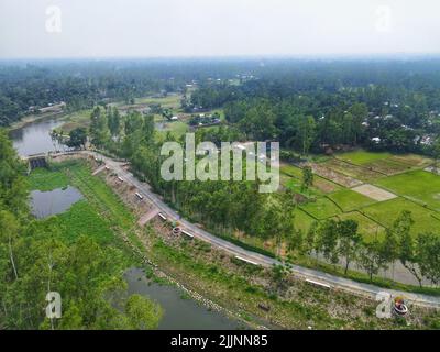 An aerial view of the flowing Karnaphuli River surrounded by greens in Bangladesh Stock Photo