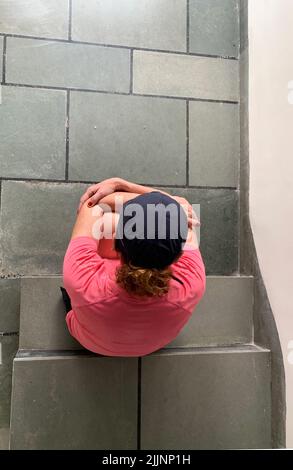 Overhead view of a runner sitting on steps before her run Stock Photo