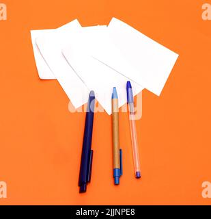 Blue corporate stationery pens on blank white paper notes for company to print their logos Stock Photo